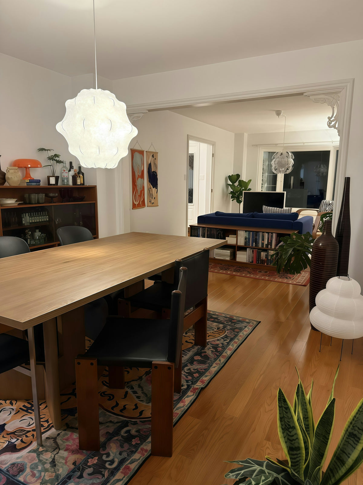 Dining and living room lit with paper pendant lamps