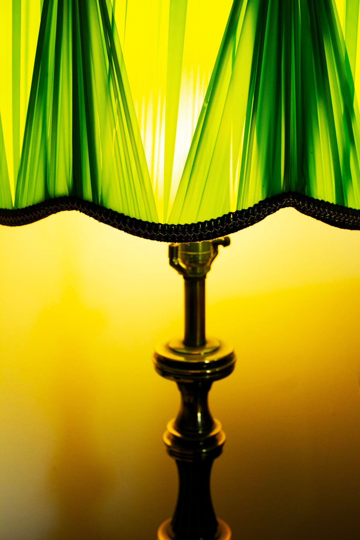Green pleated lamp shade glowing
