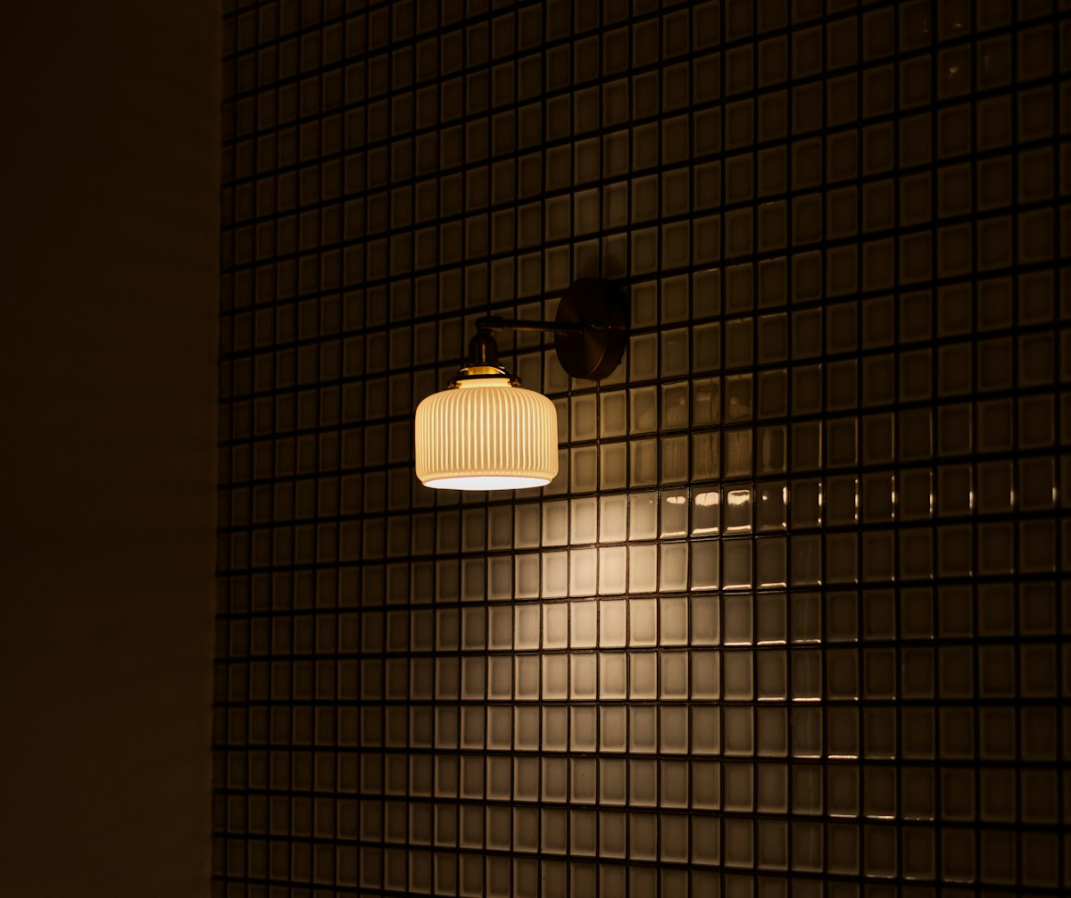 Ribbed glass wall light on tiles