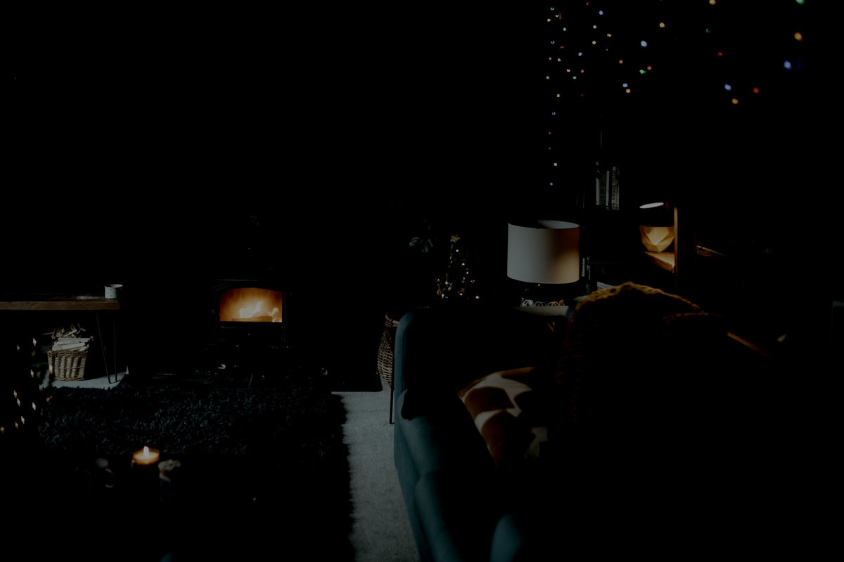 The same living room with most lights off