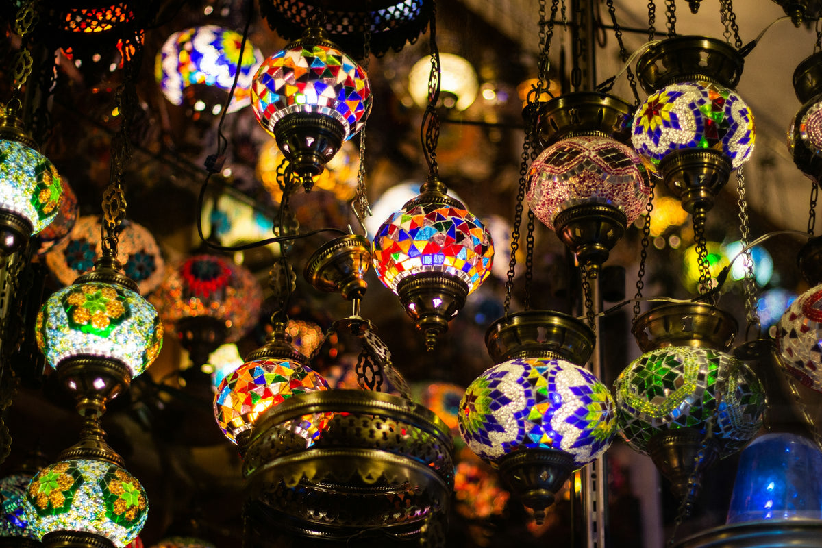Assorted hanging lamps lit in a lighting showroom